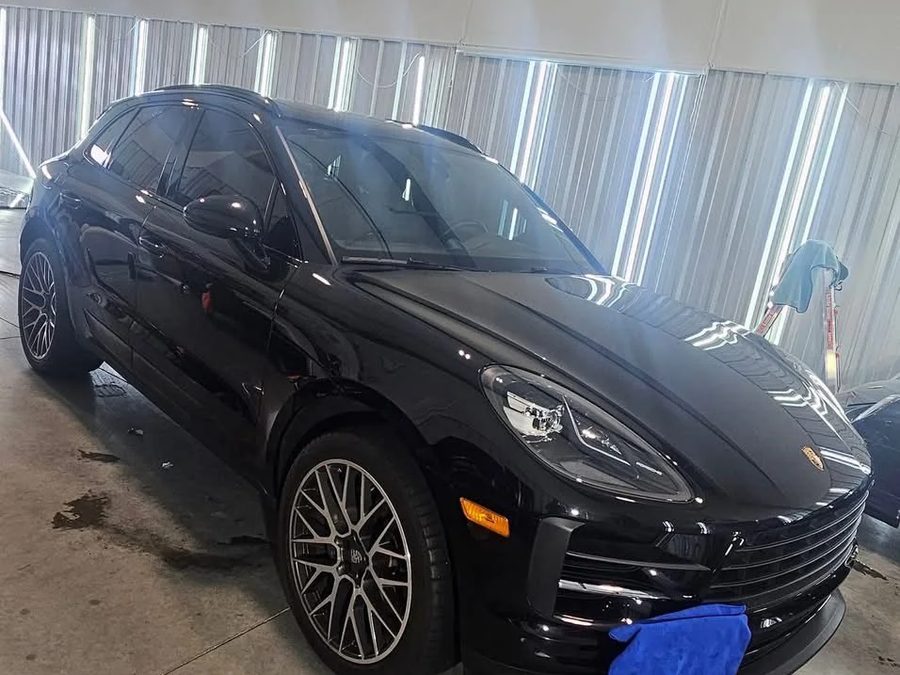 Detailed black Porsche Macan in the shop
